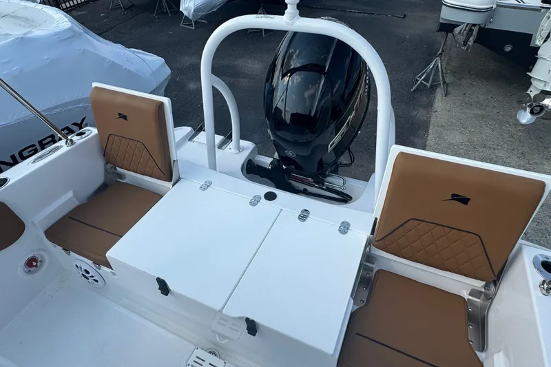 Slide: The Image of 2027 Stingray 17 CC boat interior with brown seating and outboard motor. - 4