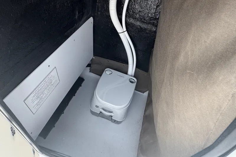 Slide: The Image of Portable toilet inside 2027 Stingray 17 CC boat compartment. - 17