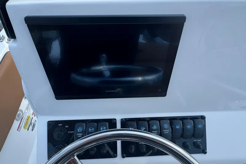 Slide: The Image of Dashboard of a 2027 Stingray 17 CC boat with Garmin display and control panel. - 11