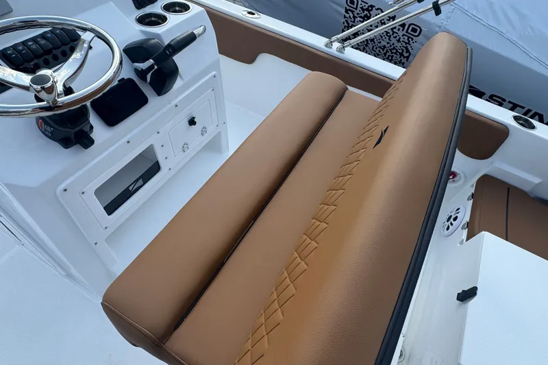 Slide: The Image of 2027 Stingray 17 CC boat interior with brown seating and steering console. - 7