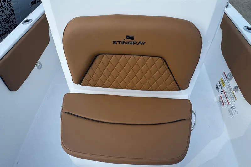Slide: The Image of Brown leather seating on 2027 Stingray 17 CC boat, featuring quilted design and logo. - 19