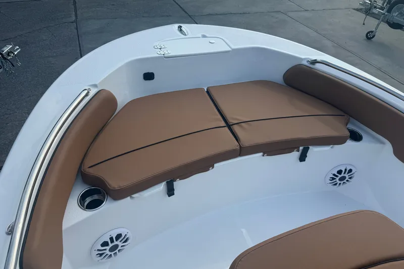 Slide: The Image of 2027 Stingray 17 CC boat interior with brown cushioned seating and stainless steel railings. - 20