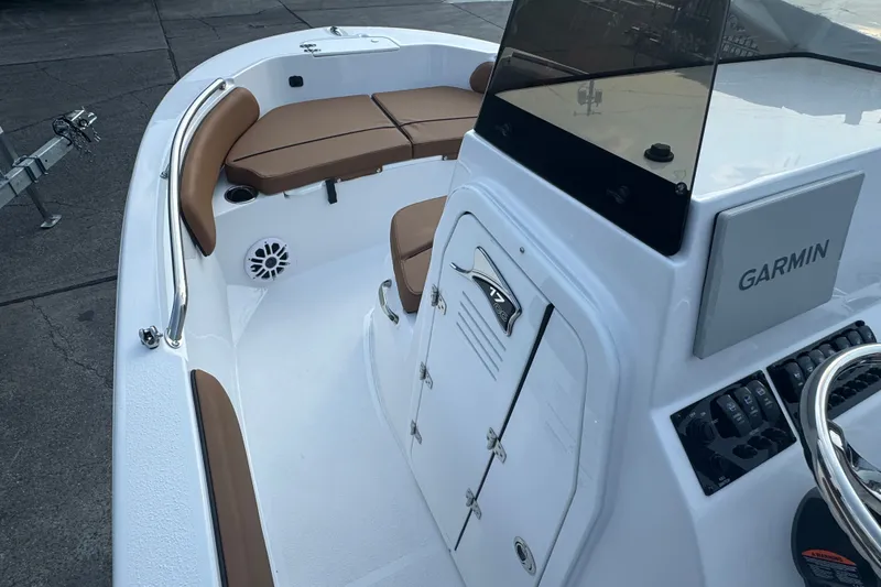 Slide: The Image of 2027 Stingray 17 CC boat interior with Garmin navigation, brown seating, and control panel. - 15