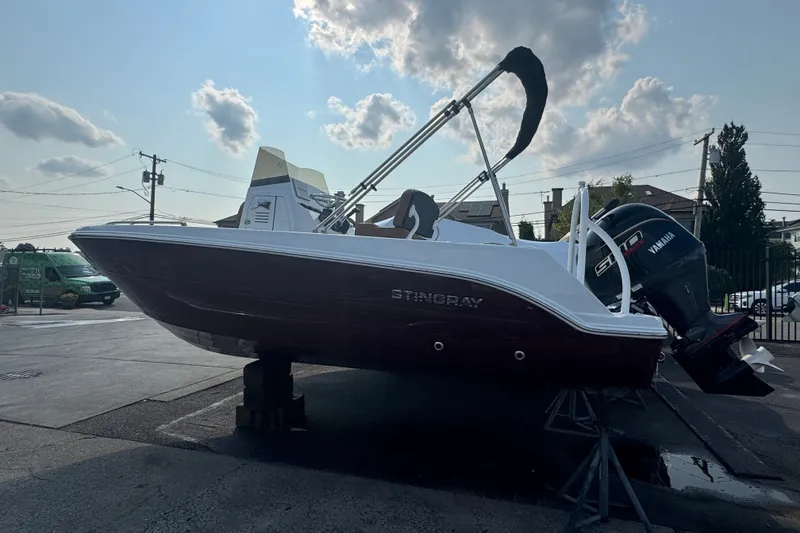 The Image of 2027 Stingray 17 CC boat with Yamaha engine on display outdoors. - 1