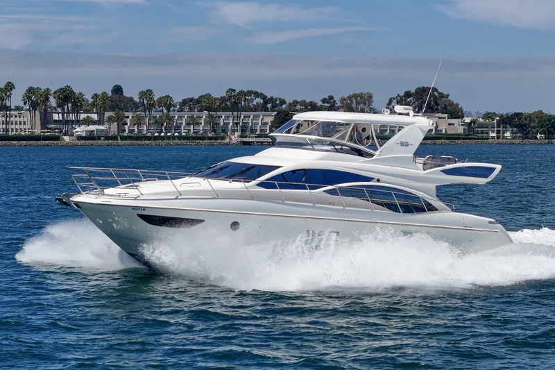 Slide: The Image of Luxurious 2010 Azimut 58 yacht cruising on blue waters near a scenic coastline. - 20