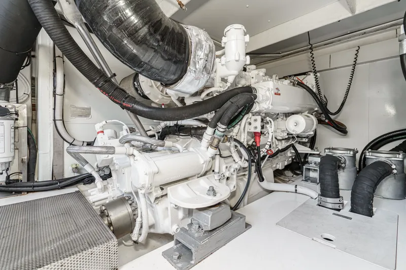 Slide: The Image of Engine room of a 2010 Azimut 58 yacht, showcasing mechanical components and piping. - 105