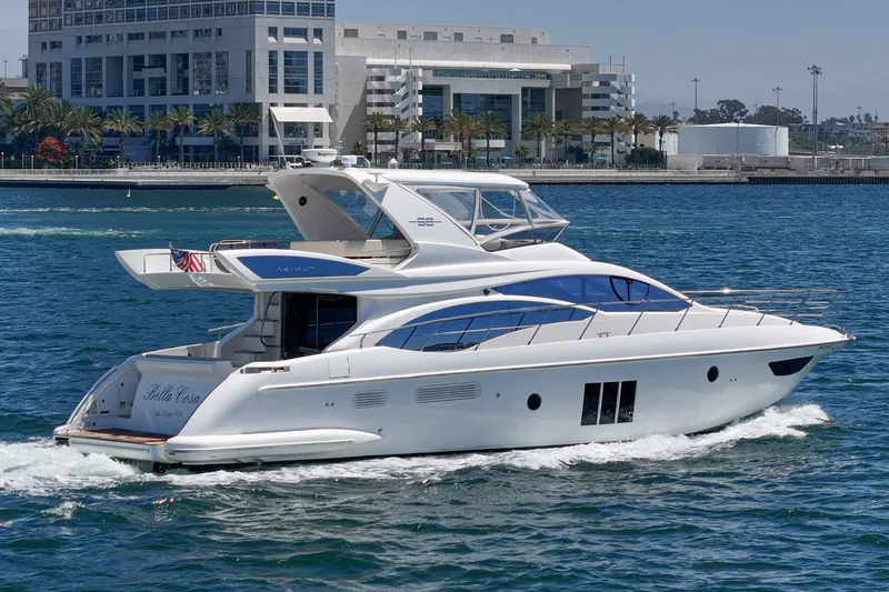 Slide: The Image of Luxury 2010 Azimut 58 yacht cruising in a scenic waterfront setting. - 17