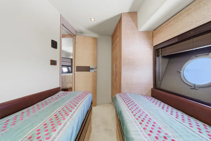 Slide: The Image of Interior of 2010 Azimut 58 yacht cabin with twin beds and porthole window. - 85
