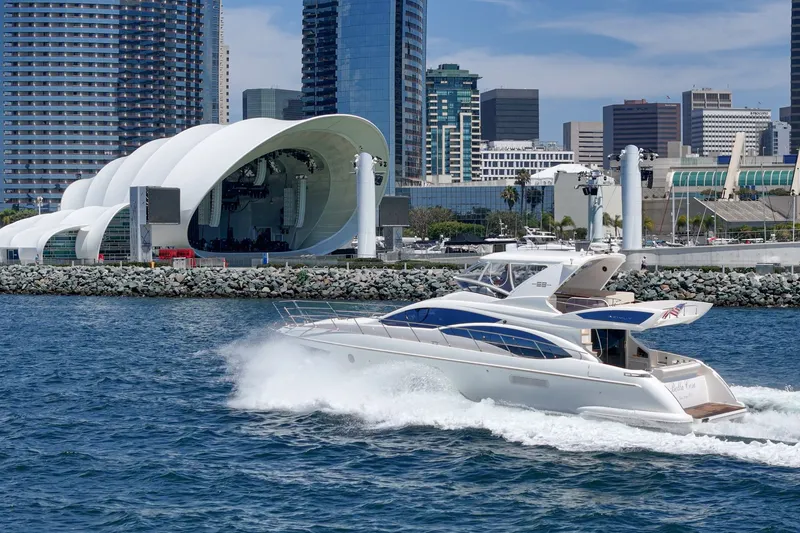 Slide: The Image of Luxury 2010 Azimut 58 yacht cruising near modern waterfront architecture and city skyline. - 30
