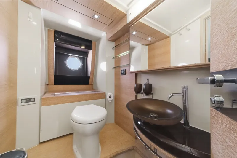 Slide: The Image of Luxurious bathroom interior of a 2010 Azimut 58 yacht, featuring modern fixtures and elegant design. - 95