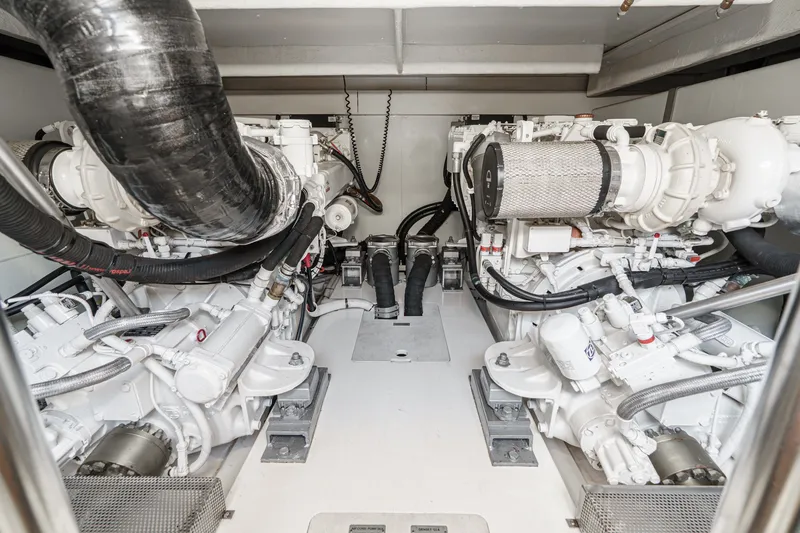 Slide: The Image of Engine room of a 2010 Azimut 58 yacht, showcasing dual engines and mechanical components. - 104