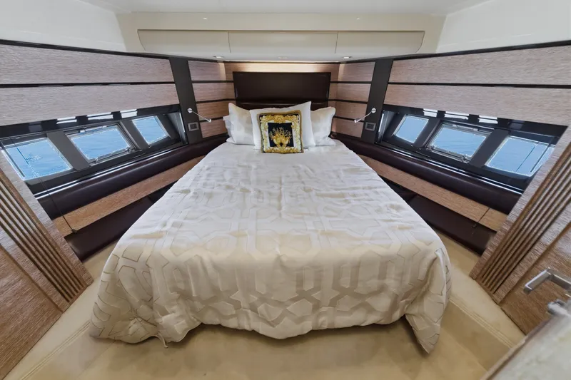Slide: The Image of Luxurious bedroom interior of a 2010 Azimut 58 yacht with elegant bedding and windows. - 80