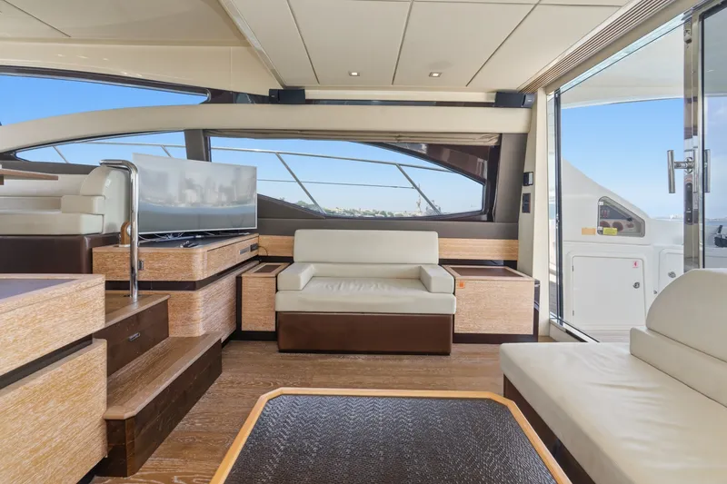 Slide: The Image of Luxurious interior of 2010 Azimut 58 yacht with modern seating and large windows. - 62