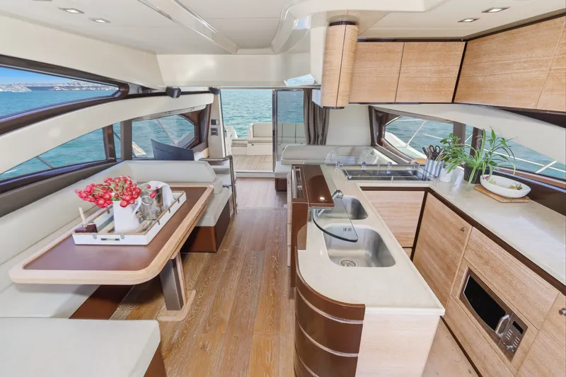 Slide: The Image of Luxurious interior of 2010 Azimut 58 yacht with modern kitchen and dining area. - 68