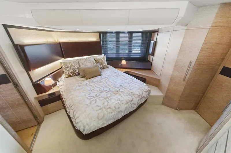 Slide: The Image of Luxurious bedroom interior of 2010 Azimut 58 yacht with elegant bedding and ambient lighting. - 90