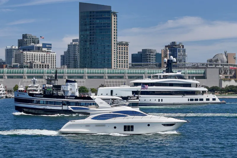 Slide: The Image of Azimut 58 yacht cruising in urban harbor with city skyline, 2010 model. - 25