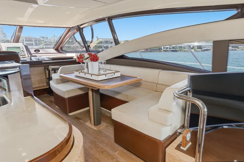 Slide: The Image of Luxurious interior of a 2010 Azimut 58 yacht with elegant seating and dining area. - 65