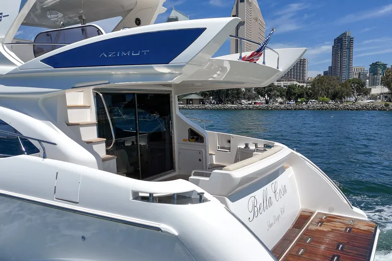 Slide: The Image of Luxury 2010 Azimut 58 yacht cruising near city skyline, featuring elegant design and spacious deck. - 53
