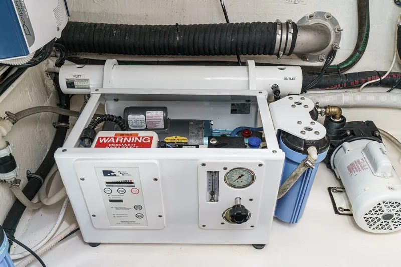 Slide: The Image of Engine room equipment of a 2010 Azimut 58 yacht, featuring a water filtration system. - 101