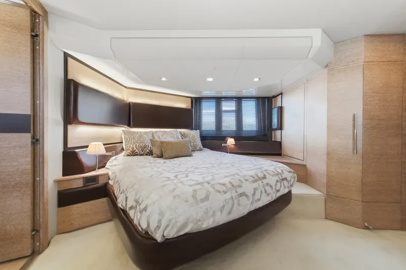 Slide: The Image of Luxurious bedroom interior of a 2010 Azimut 58 yacht, featuring elegant design and cozy lighting. - 89