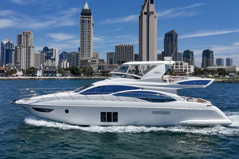 Slide: The Image of Luxury 2010 Azimut 58 yacht cruising near city skyline on a sunny day. - 31
