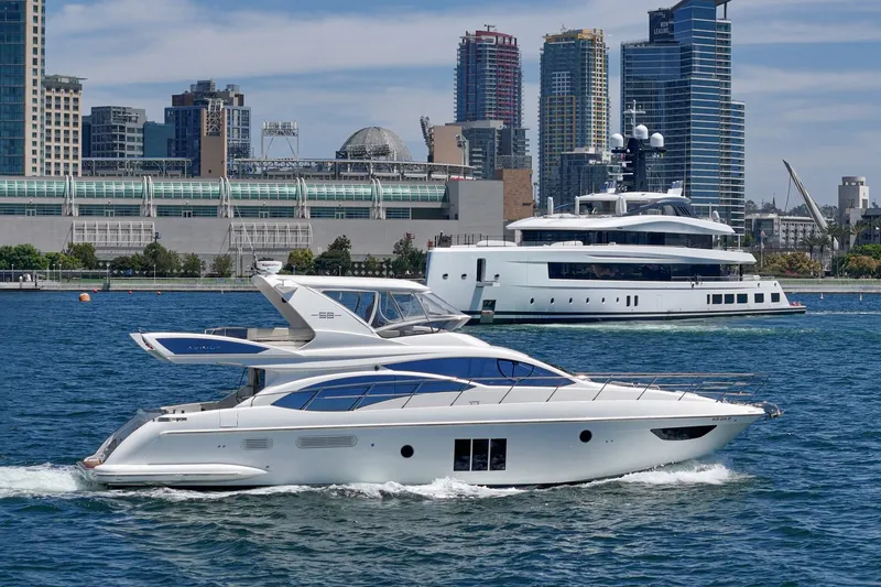 Slide: The Image of 2010 Azimut 58 yacht cruising in urban waterfront setting with skyscrapers. - 24