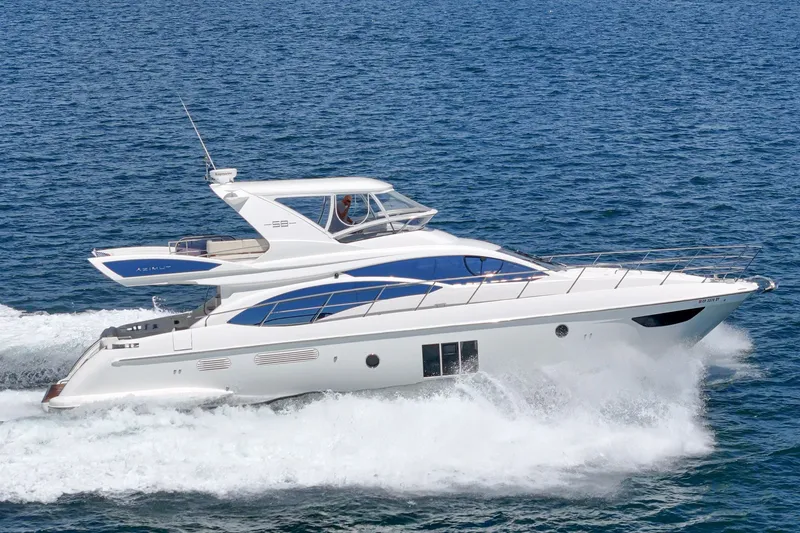 Slide: The Image of Luxury 2010 Azimut 58 yacht cruising on open sea, showcasing sleek design and elegance. - 21