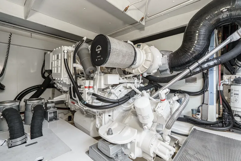 Slide: The Image of Engine room of a 2010 Azimut 58 yacht, showcasing mechanical components and piping. - 106
