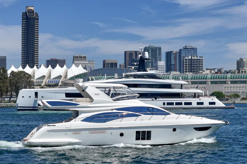 Slide: The Image of Azimut 58 yacht cruising in urban harbor, 2010 model, city skyline backdrop. - 27