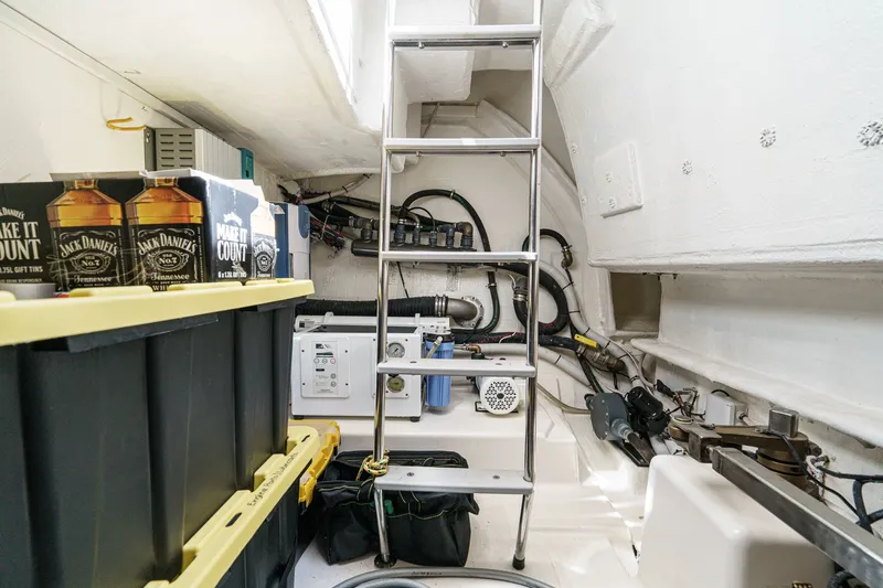 Slide: The Image of Engine room of a 2010 Azimut 58 yacht with storage and equipment. - 100