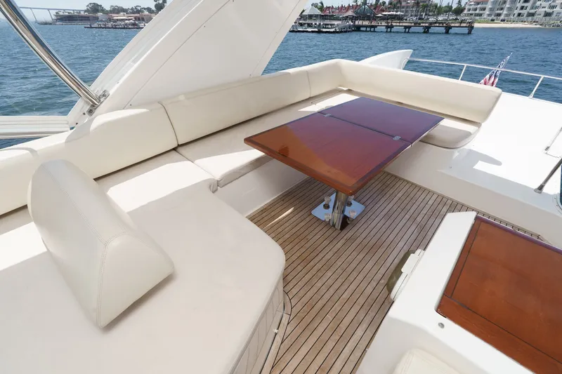 Slide: The Image of Luxurious seating area on a 2010 Azimut 58 yacht with wooden table and waterfront view. - 49