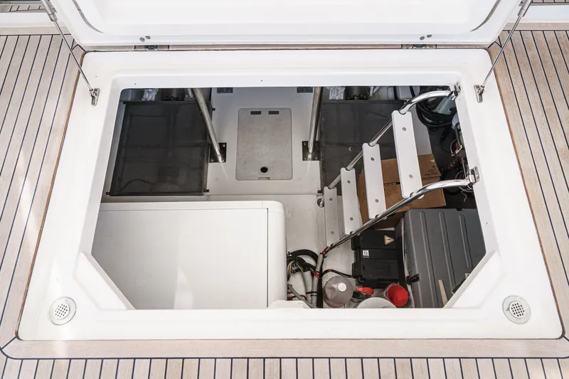Slide: The Image of Engine compartment of a 2010 Azimut 58 yacht, featuring steps and equipment. - 103