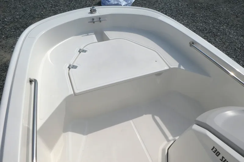 Slide: The Image of 2027 Boston Whaler 130 Super Sport boat interior with storage compartment and seating. - 9