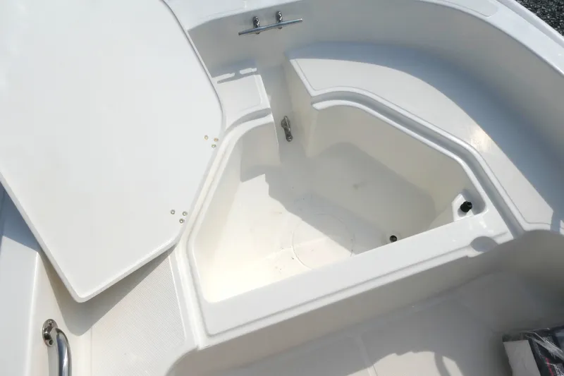 Slide: The Image of 2027 Boston Whaler 130 Super Sport boat storage compartment, open and empty. - 10