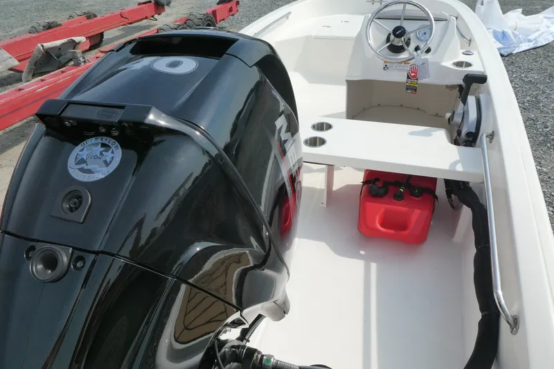 Slide: The Image of 2027 Boston Whaler 130 Super Sport boat interior with engine and steering wheel. - 4