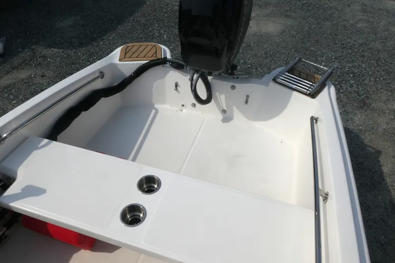 Slide: The Image of 2027 Boston Whaler 130 Super Sport boat interior with seating and cup holders. - 5