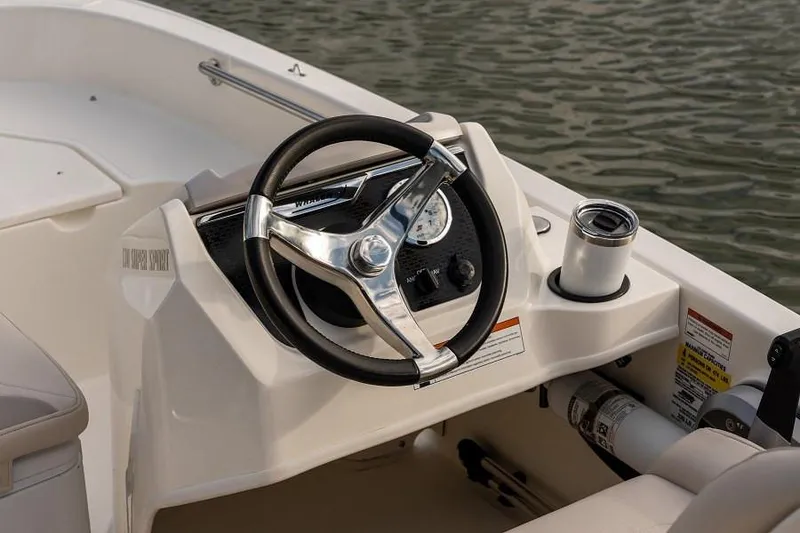 Slide: The Image of Manufacturer Provided Image: 2025 Boston Whaler 130 Super Sport steering console with modern design and controls. - 14
