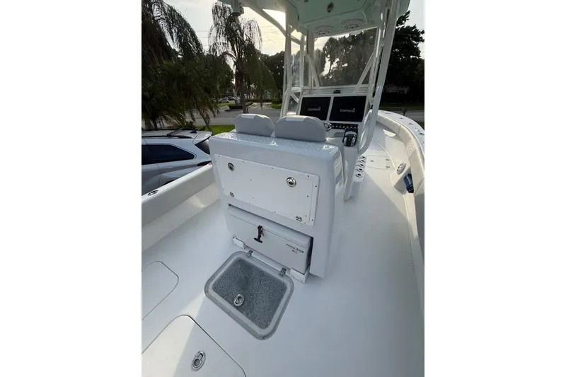Slide: The Image of 2019 Conch 30 boat interior with helm, seating, and Garmin displays. - 15
