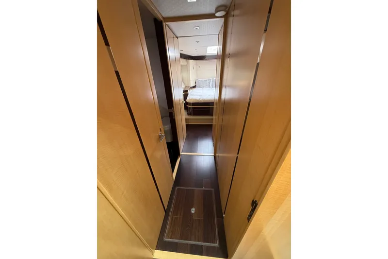 Slide: The Image of Interior hallway of 2014 Sunseeker Predator 68 yacht, featuring wooden finishes and bedroom view. - 49