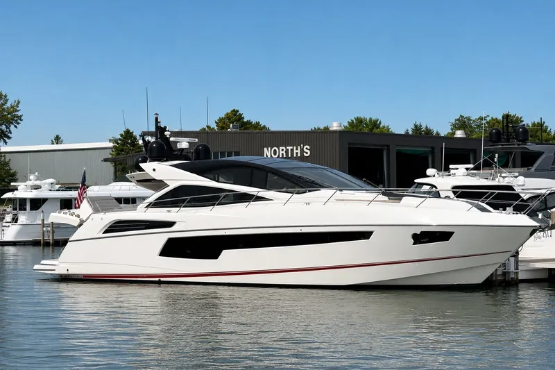 The Image of 2014 Sunseeker Predator 68 yacht docked at marina, sleek design, sunny day. - 0