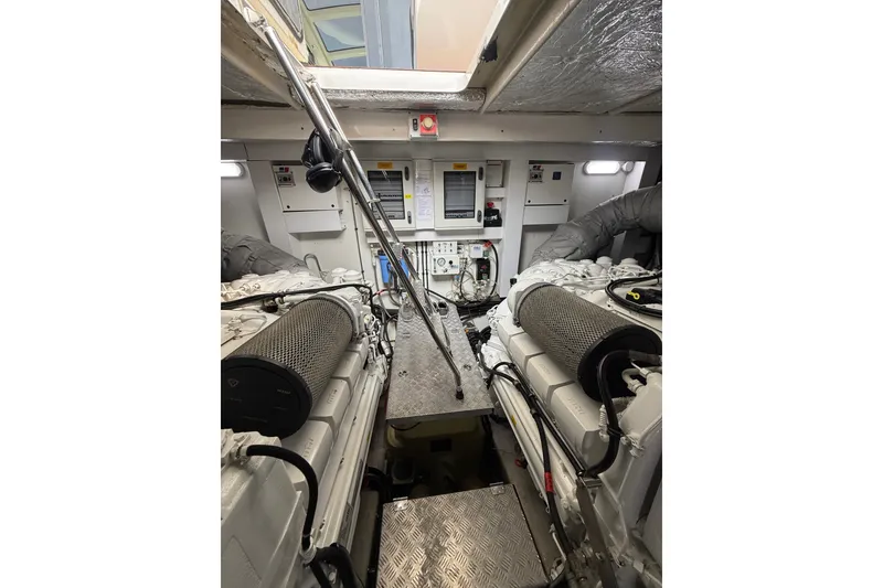 Slide: The Image of Engine room of 2014 Sunseeker Predator 68 yacht, featuring dual engines and control panels. - 62