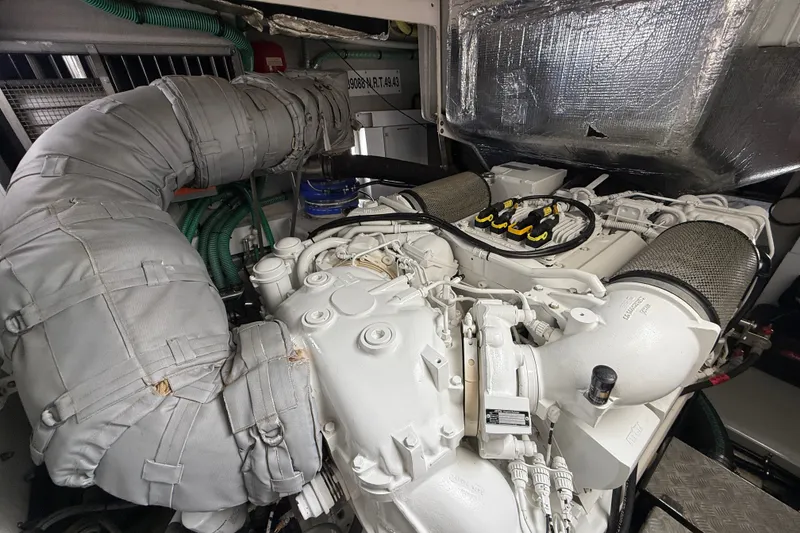Slide: The Image of Engine room of a 2014 Sunseeker Predator 68 yacht, showcasing detailed machinery. - 55