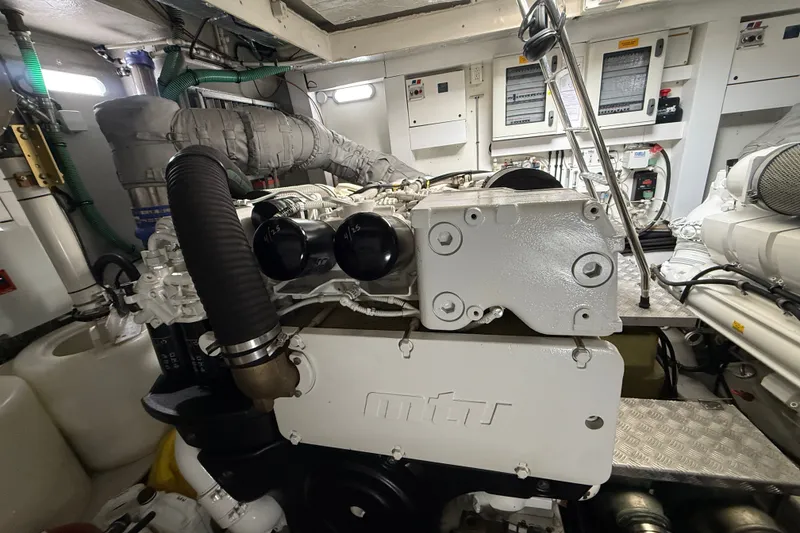 Slide: The Image of Engine room of 2014 Sunseeker Predator 68 yacht, showcasing detailed machinery and components. - 56