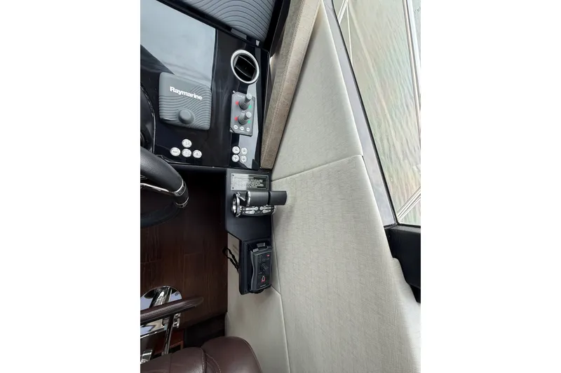Slide: The Image of Interior helm controls of 2014 Sunseeker Predator 68 yacht, featuring Raymarine equipment. - 51