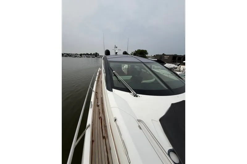 Slide: The Image of 2014 Sunseeker Predator 68 yacht docked, showcasing sleek design and luxurious features. - 19