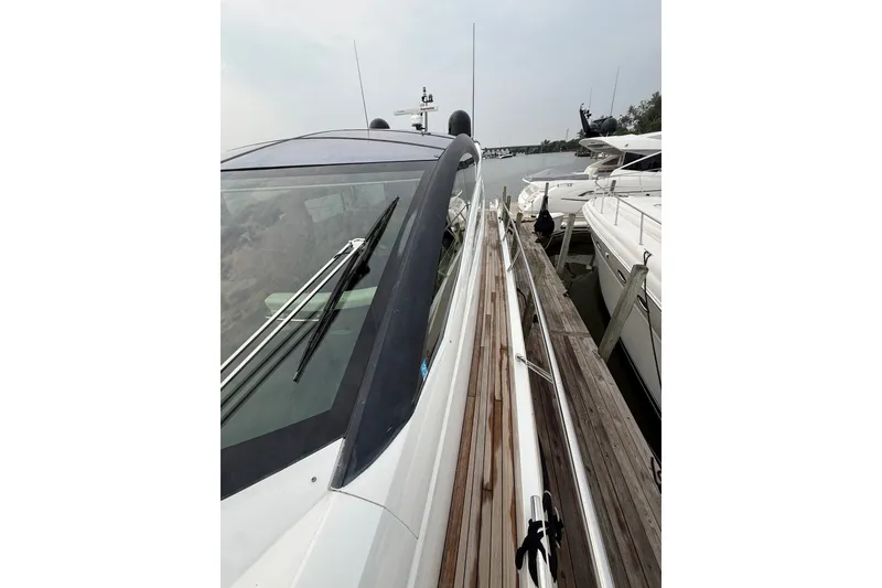 Slide: The Image of 2014 Sunseeker Predator 68 yacht docked, showcasing sleek design and modern features. - 22