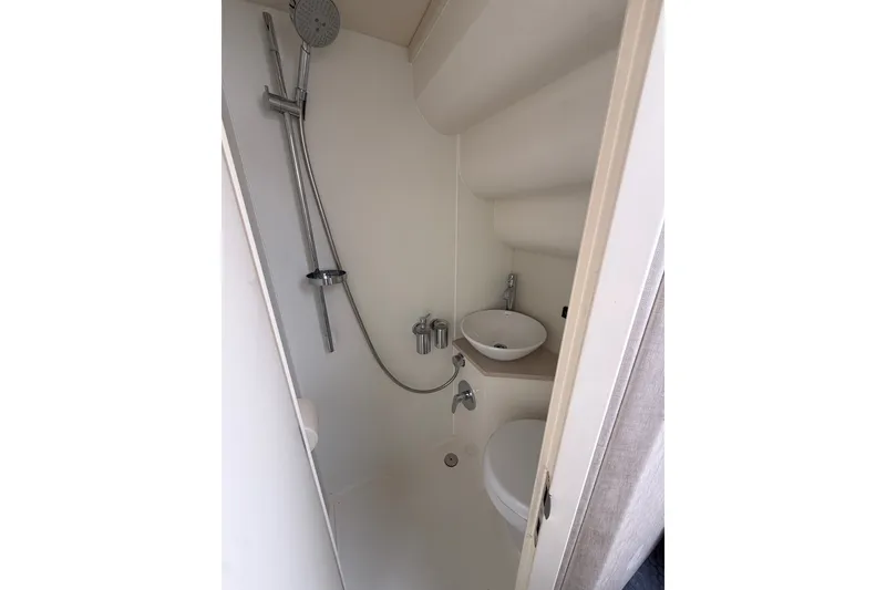 Slide: The Image of Compact bathroom in 2014 Sunseeker Predator 68 yacht with shower, sink, and toilet. - 53