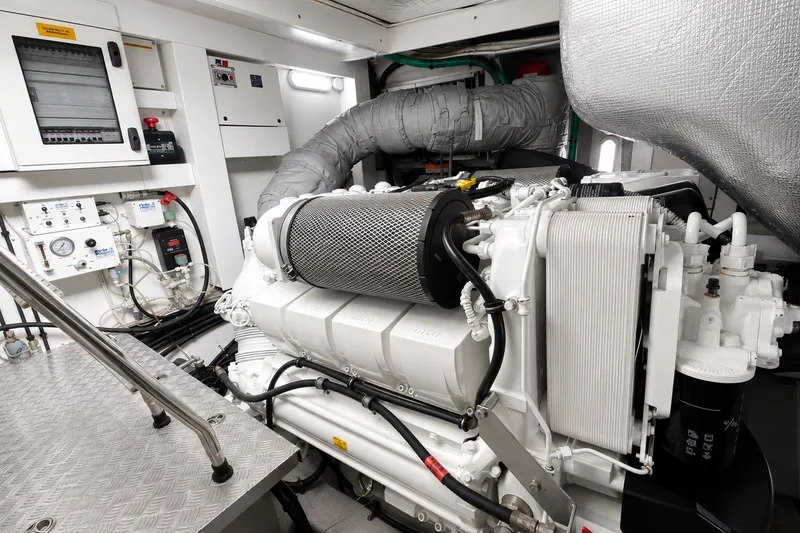 Slide: The Image of Engine room of a 2014 Sunseeker Predator 68 yacht, showcasing advanced machinery and controls. - 64