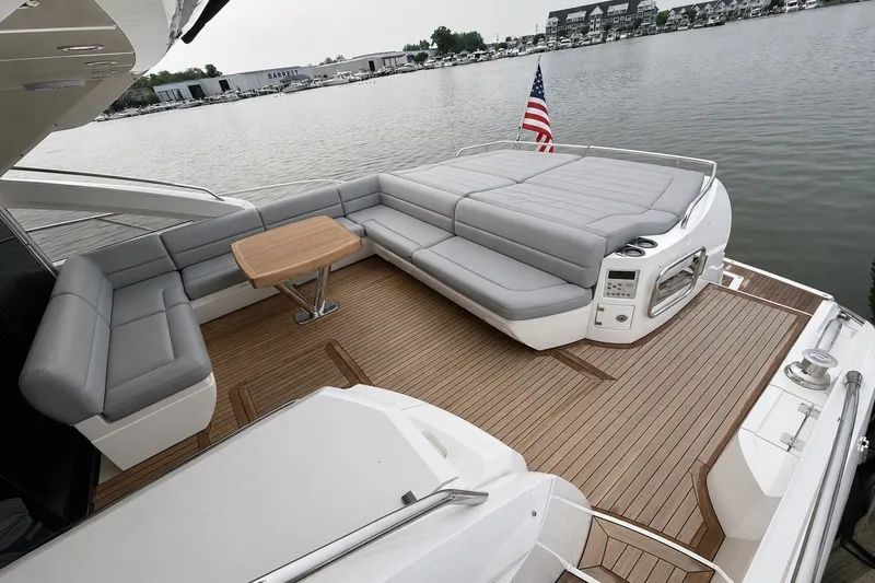 Slide: The Image of Luxurious 2014 Sunseeker Predator 68 yacht deck with seating and American flag. - 16