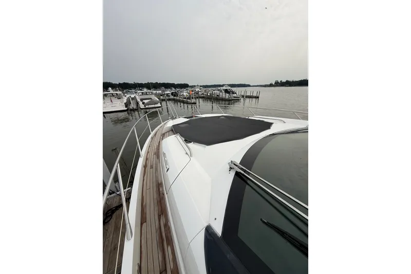 Slide: The Image of 2014 Sunseeker Predator 68 yacht docked at a marina, showcasing sleek design and luxury. - 20